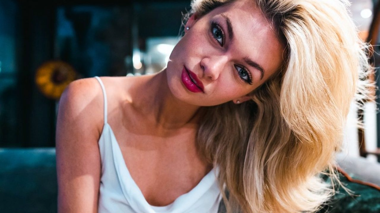 A close-up portrait of a woman with blonde hair and a soft, contemplative expression, captured by luxury lifestyle photographer Cristo Noir. Landonbuford.com