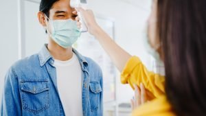 Asia female receptionist conducting wear protective face mask us