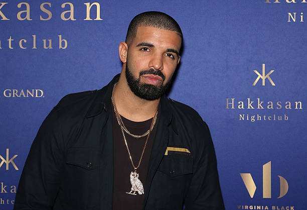 Drake performing on stage amid swirling legal controversy with Universal Music Group regarding defamation and sabotage allegations. Landonbuford.com