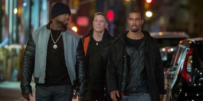 Power's Ghost, Tommy Egan, and Kanan Stark walk down a city street at night looking serious and focused, wearing dark jackets. The background shows blurred street lights and parked cars. LandonBuford.com