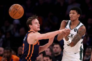 Milwaukee Bucks player MarJon Beauchamp attempts a pass while being tightly guarded by New York Knicks guard Ryan Arcidiacono during an NBA game. LandonBuford.com