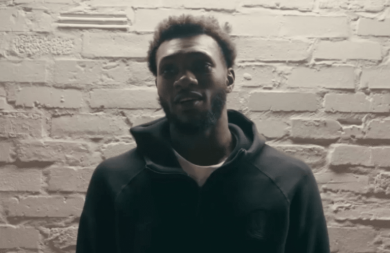 Moussa Cissé in a Dallas Mavericks practice or game setting, highlighting his length and defensive presence.