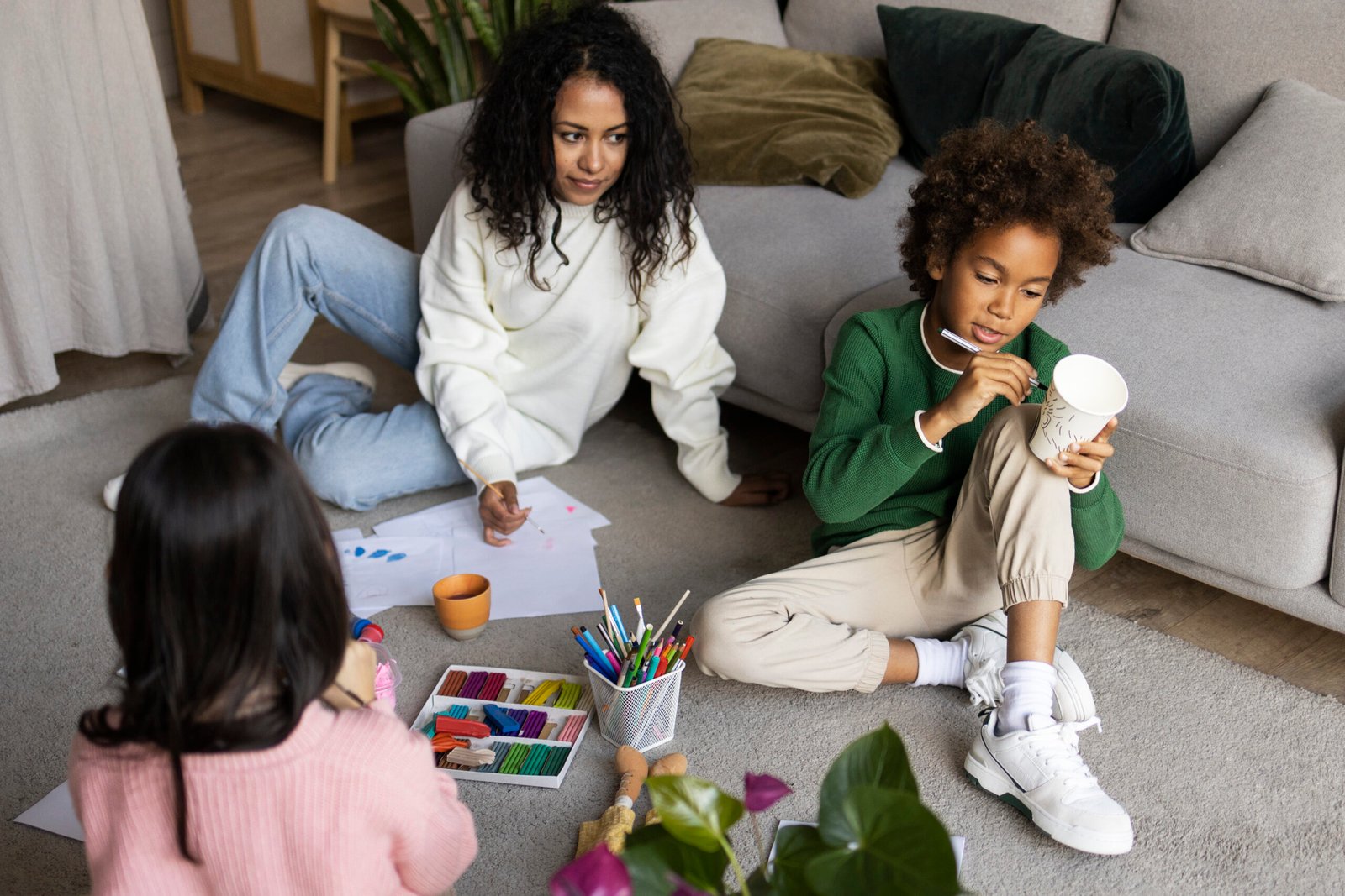 A young child playing and sharing toys with friends in a preschool classroom.