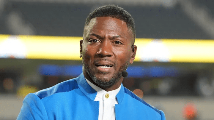 Head-and-shoulders portrait of Ryan Clark in a studio setting, smiling, with ESPN branding in the background.