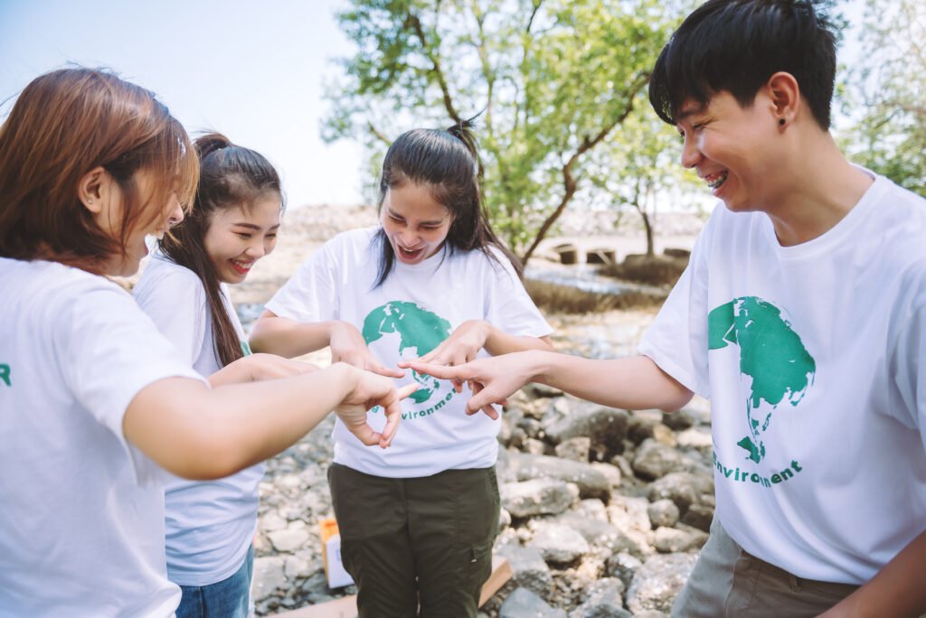Volunteer engaging with local children in a Southeast Asian village during a community project.