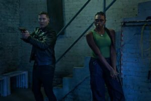 Tommy Egan and Shanti Page stand over fallen cartel members after a gunfight in Power Book IV: Force Season 3 premiere.