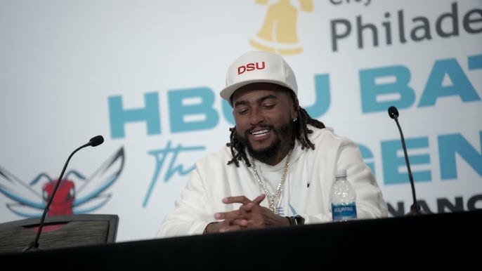 DeSean Jackson coaching on the sideline during a Delaware State University football game.