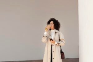 Model wearing a minimalist neutral-toned outfit with clean lines and simple accessories, showcasing the effortless fashion trend of 2025.