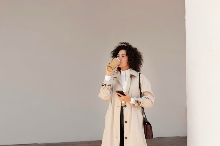 Model wearing a minimalist neutral-toned outfit with clean lines and simple accessories, showcasing the effortless fashion trend of 2025.