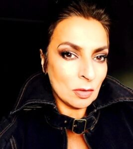 Actress Alice Amter smiling on a red carpet at Sundance, with film banners in the background.