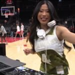 Japanese female DJ performing courtside at an Atlanta Hawks NBA game.