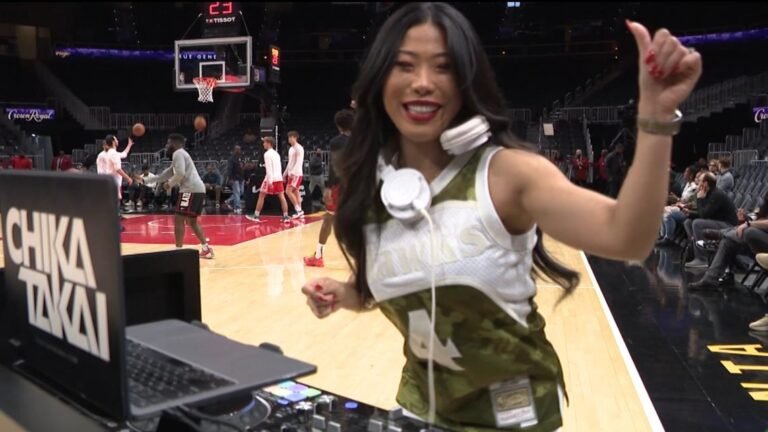 Japanese female DJ performing courtside at an Atlanta Hawks NBA game.